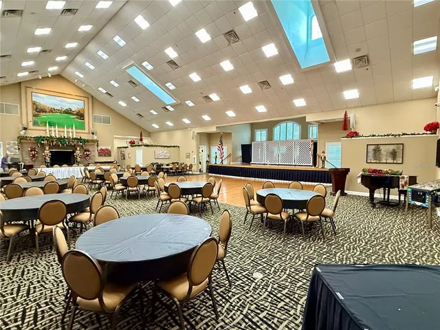 a room with gym equipment and wooden floor