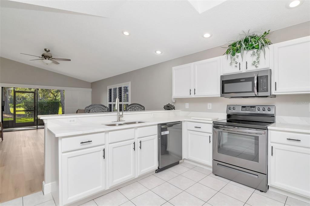 9500 Green Needle Drive New Port Richey, FL 34655 - Photo 5 of 28 a kitchen with a sink stove and cabinets