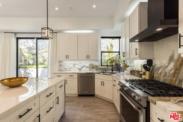 a kitchen with sink stove and refrigerator