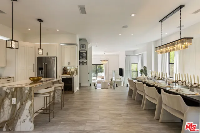 a large kitchen with a table and chairs