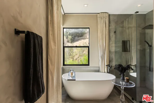 a bathroom with a tub and a shower