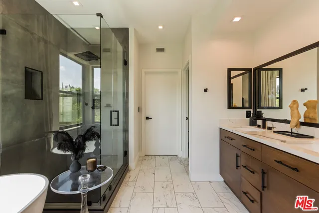a bathroom with a sink a toilet and a mirror