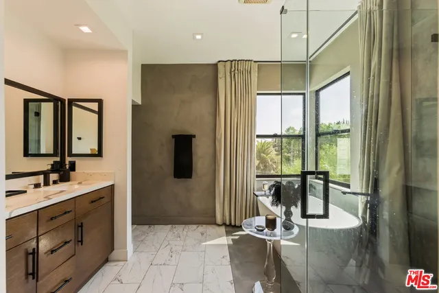 a view of a bathroom with dual sinks