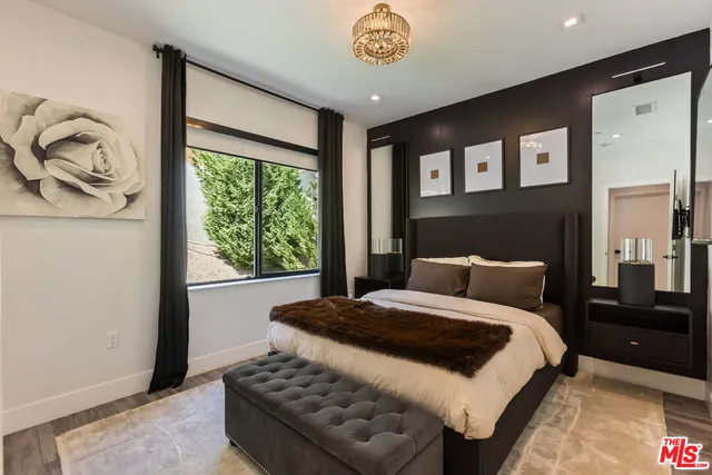 a bedroom with a large bed and a window