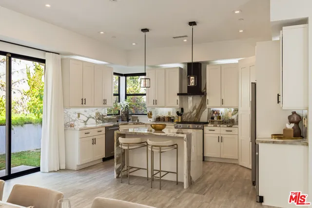 a kitchen with a sink stove and refrigerator