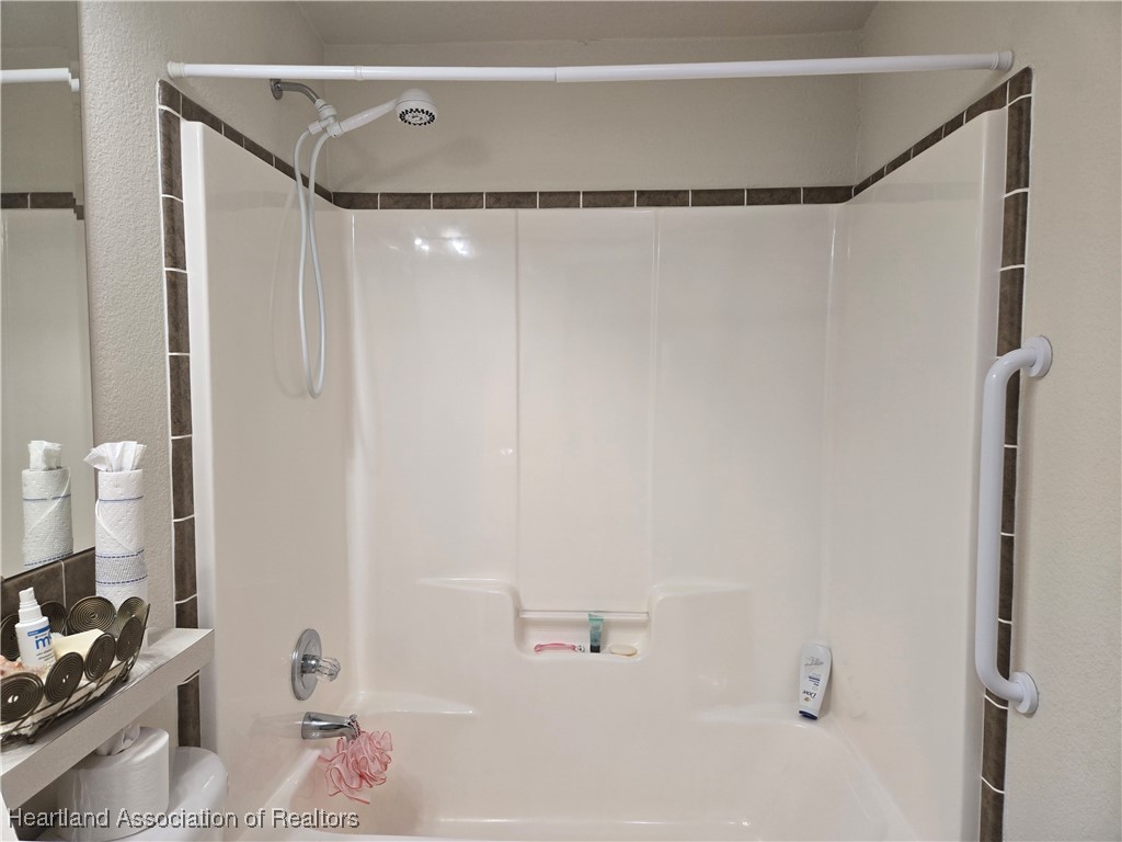 3312 Beartooth Pass Sebring, FL 33872 - Photo 18 of 39 a bathroom with a shower and a tub
