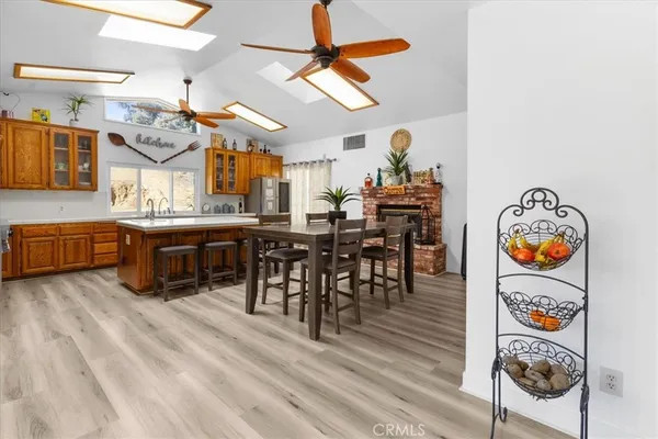 a kitchen that has a table chairs in it and wooden floors