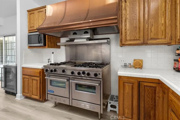 a kitchen with a stove a sink and a refrigerator