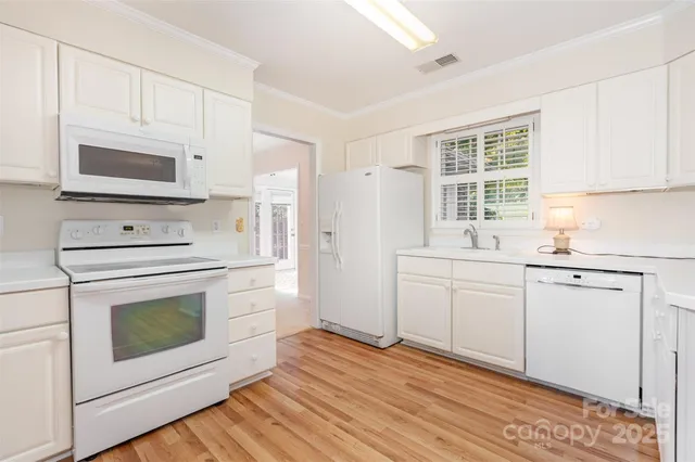 a kitchen with a refrigerator and a stove top oven