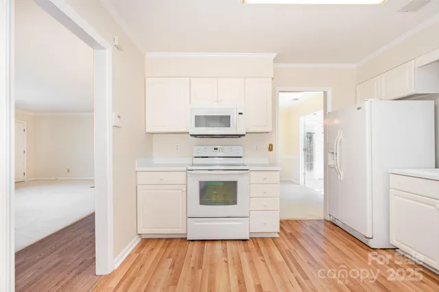 a kitchen with a sink window and cabinets