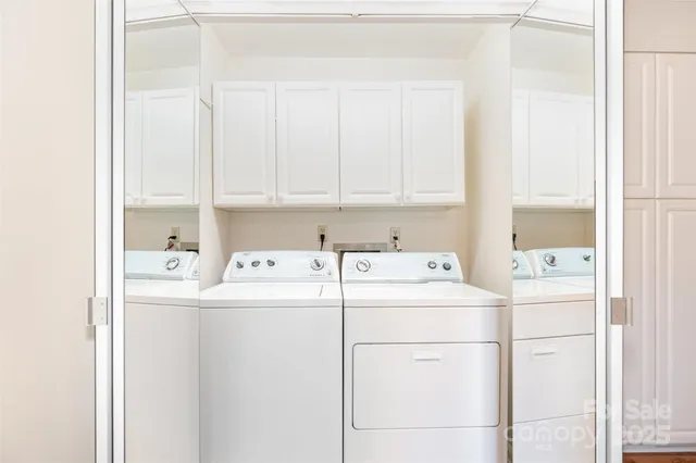 a view of a small yard in front of a house with large trees