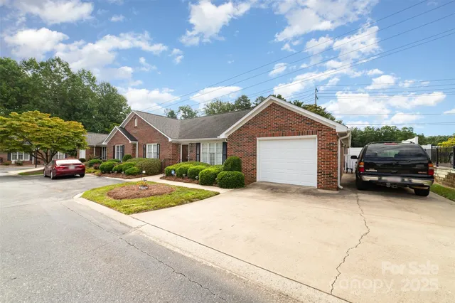 a front view of a house with cars parked