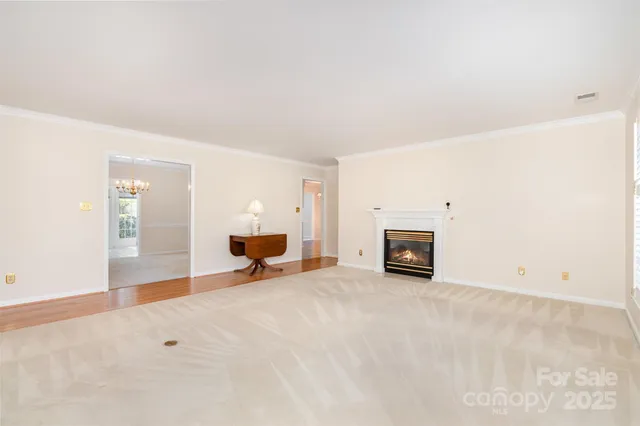 an empty room with fireplace and a window