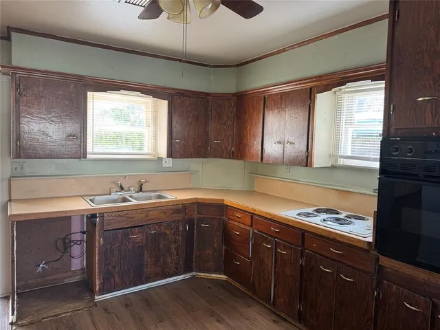 a kitchen with a sink stove and cabinets