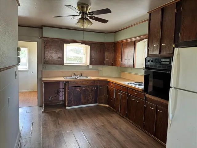 a kitchen with a sink appliances and cabinets