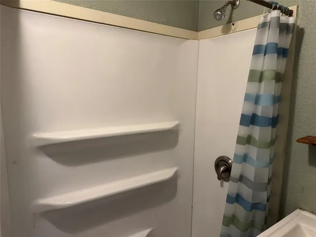 a bathroom with a shower and a toilet