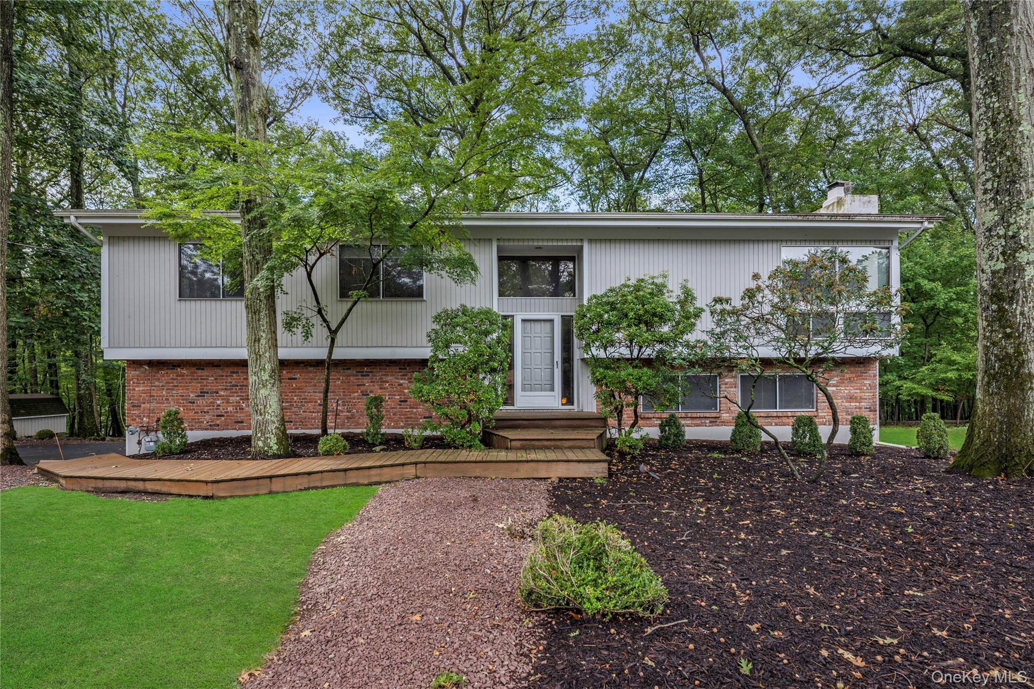 17 Sherwood Ridge Road Pomona, NY 10901 - Photo 1 of 1 Bi-level home featuring a chimney, a front yard, and brick siding