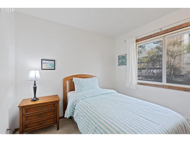a bedroom with a bed lamp and window