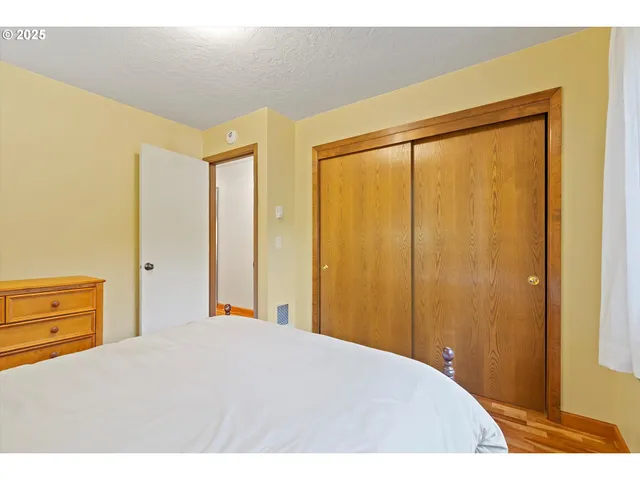 a bedroom with a bed and a dresser