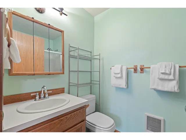 a bathroom with a sink a toilet and mirror