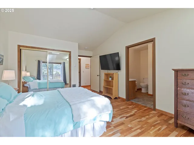 a bedroom with a bed and a television