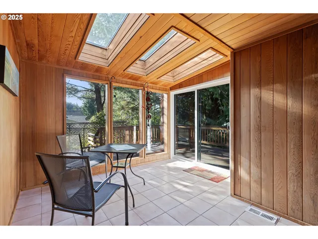 a patio with glass top table and chairs