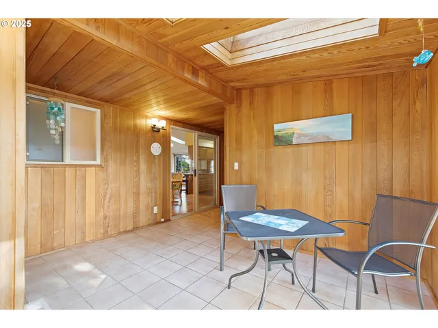 a view of a room that has a table and chair