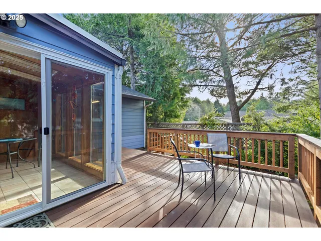 a view of balcony with chairs and wooden fence