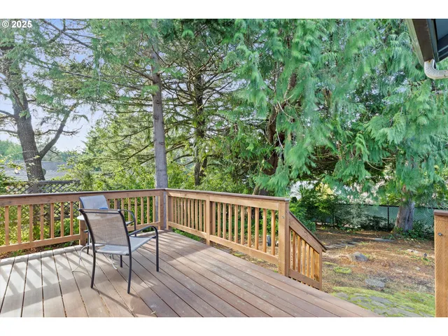 a view of a wooden deck with a yard