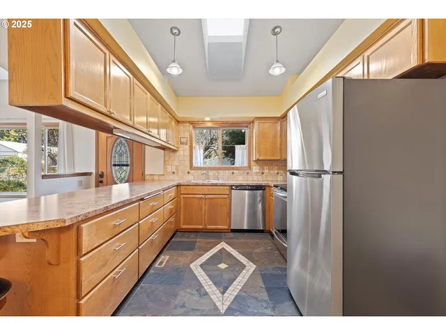 a kitchen with sink cabinets and window