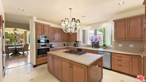 a view of a swimming pool with a table and chairs under an umbrella