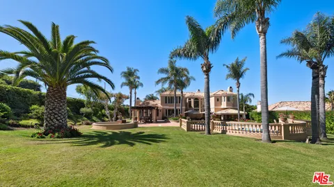a view of a chair and tables in the patio in front of a house