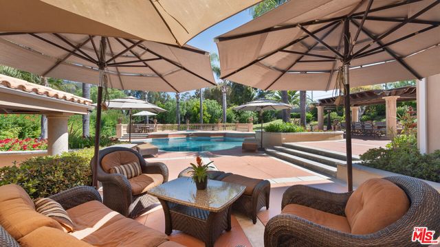 a swimming pool with trees in the background