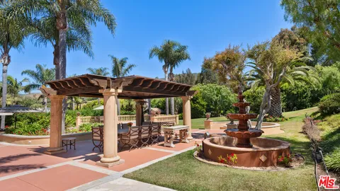 a view of a terrace with potted plants and palm trees
