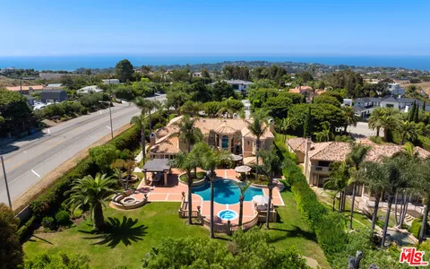 a living room with furniture and flowers