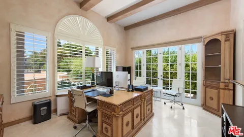 a dining room with furniture a chandelier and wooden floor