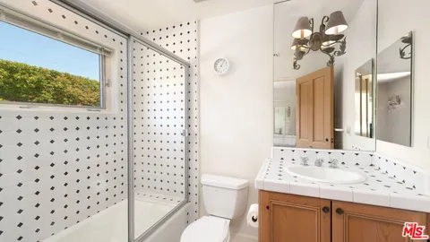 a view of a patio with a table and chairs under an umbrella