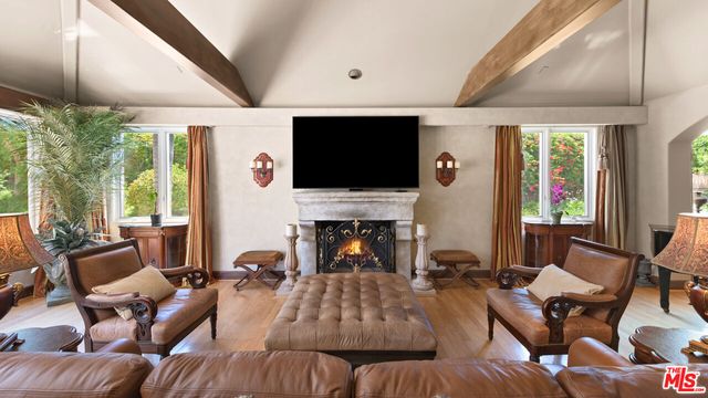 a dining room with furniture window and wooden floor