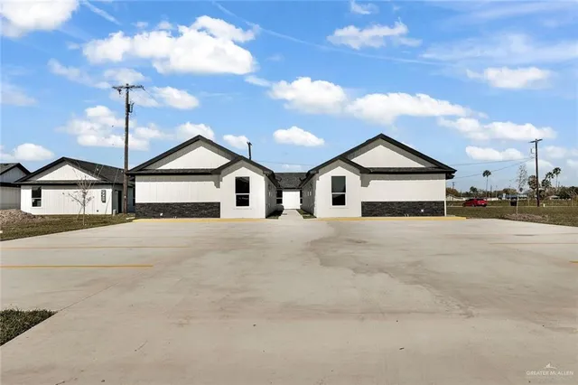 a view of white house with a road