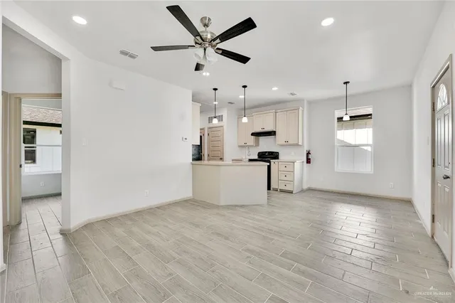 a kitchen with stainless steel appliances kitchen island a refrigerator a stove and a sink