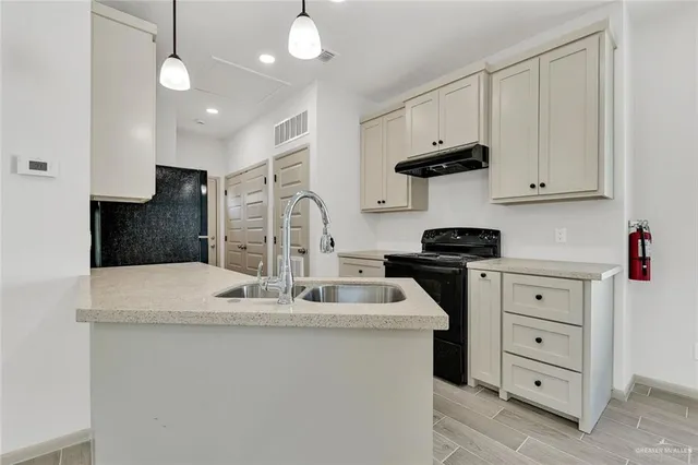a kitchen with kitchen island white cabinets and white appliances