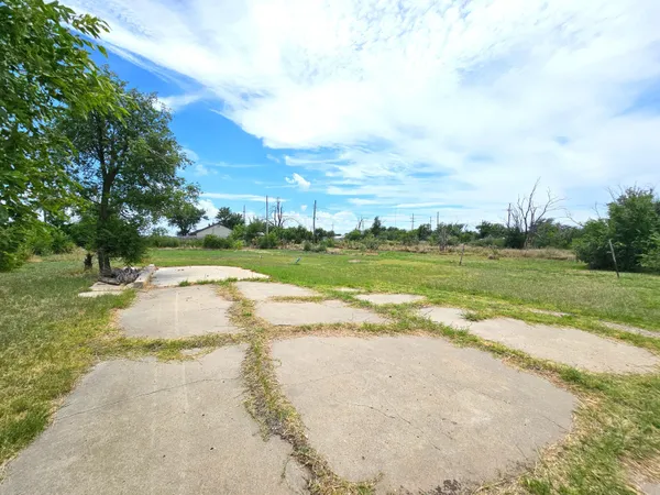 a view of a yard with swimming pool and green space