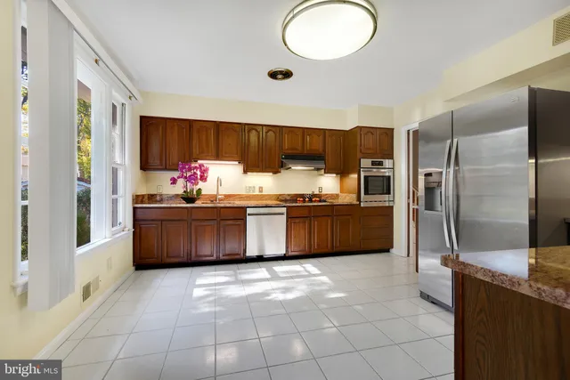 a kitchen with stainless steel appliances a refrigerator and a sink