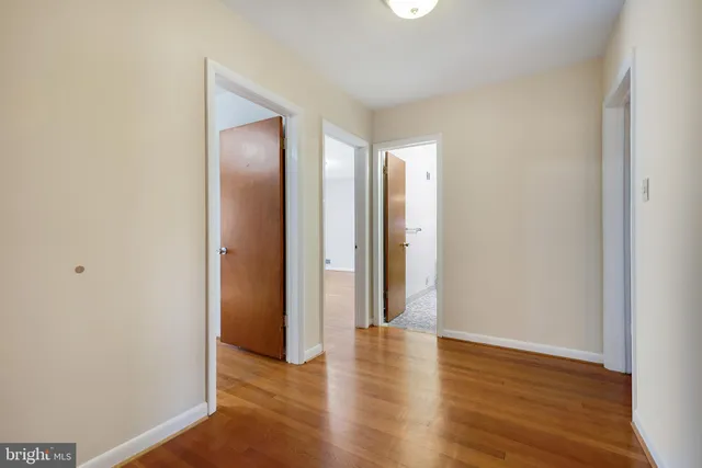 a view of hallway with wooden floor
