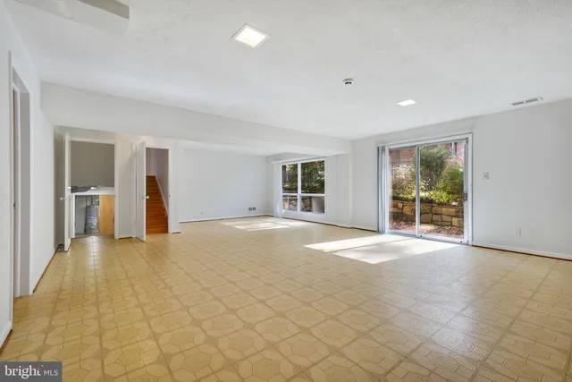 a view of an empty room with glass door