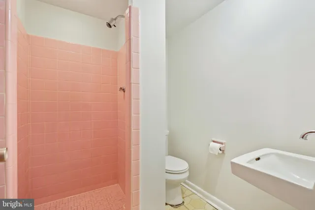 a white toilet sitting next to a bath tub