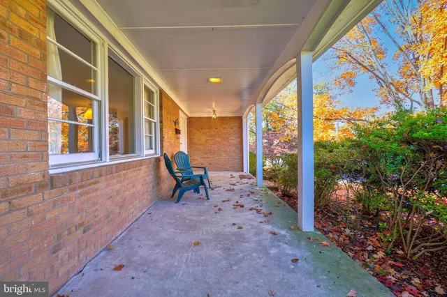 a view of a porch with chairs and backyard