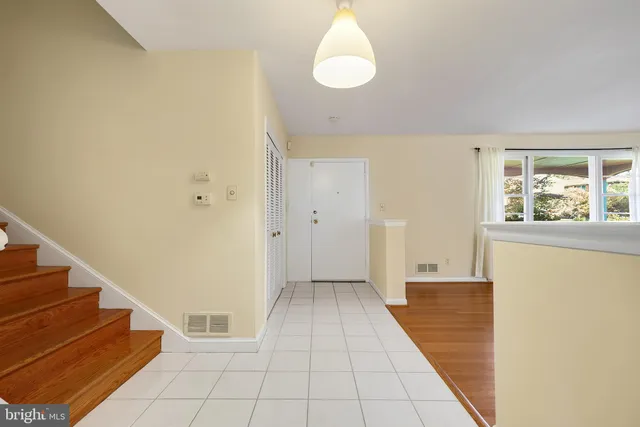 a view of a room with white walls and a window