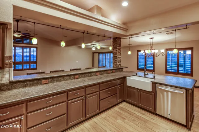 a view of a patio with a table and chairs under an umbrella