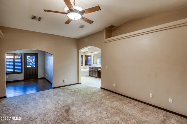 a view of living room with a floor to ceiling window and wooden floor